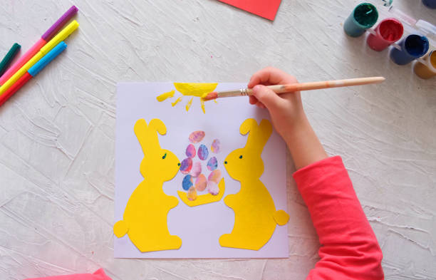 istock Child making card with Easter bunnies  from colorful paper. Applique. Handmade 1315132857