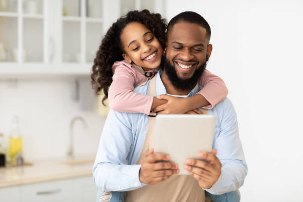 istock Happy African American family using tablet in the kitchen 1315139059