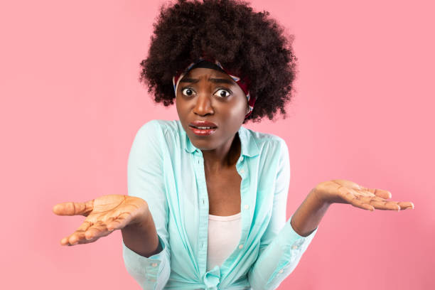 istock Puzzled African Lady Shrugging Shoulders Standing Over Pink Background 1315139352