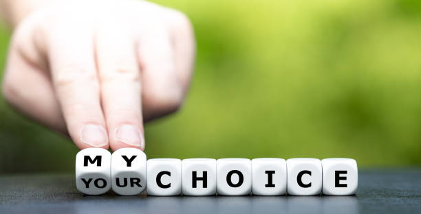 Hand turns dice and changes the expression "your choice" to "my choice". Hand turns dice and changes the expression "your choice" to "my choice". reproductive rights stock pictures, royalty-free photos & images