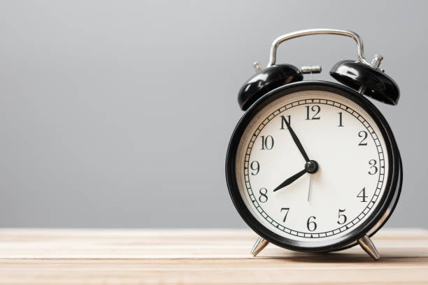 istock Vintage alarm clock on wooden table background and copy space for text. Activity, daily routine, morning, workout and Work life balance concept 1315141286