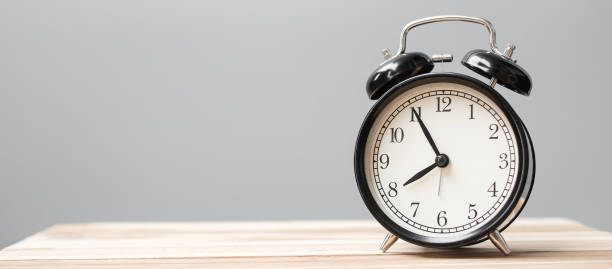istock Vintage alarm clock on wooden table background and copy space for text. Activity, daily routine, morning, workout and Work life balance concept 1315141356