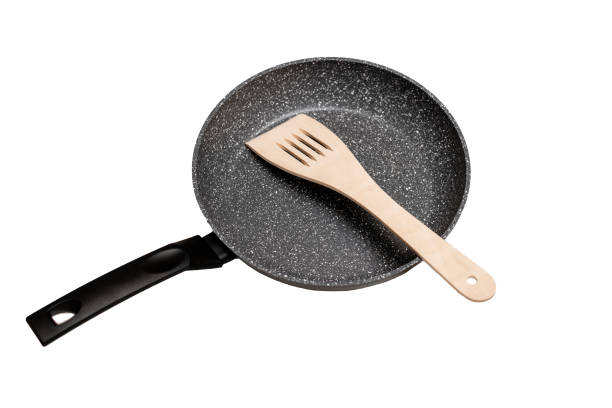 istock Frying pan with non-stick ceramic coating and spatula on a white wooden background. Cooking without sticking or oil. isolated on white background. 1315141577