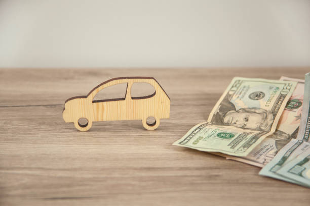 istock wooden car model with money 1315143549