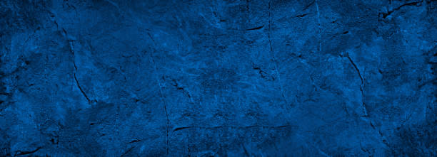 istock Abstract blue background. Toned rock texture looks like old on a concrete wall with cracks. 1315145083