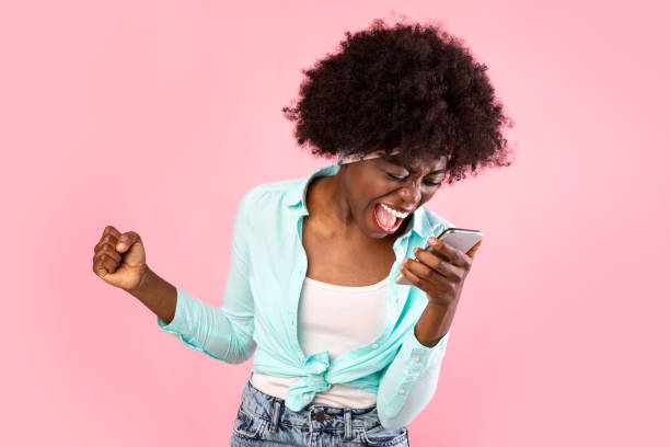 istock Emotional Black Millennial Lady Shouting At Smartphone Over Pink Background 1315146338