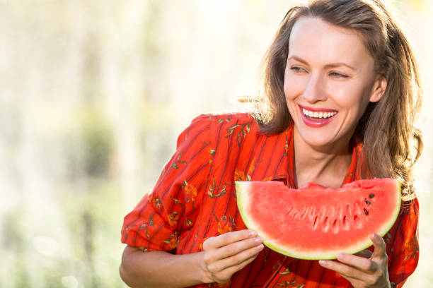 istock Beautiful woman eating watermelon 1315147442