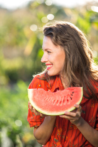 istock Beautiful woman eating watermelon 1315147444