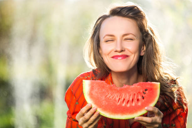 istock Beautiful woman eating watermelon 1315147459