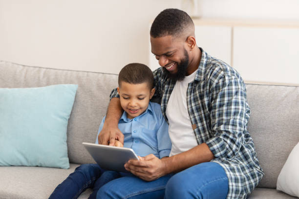 istock African Daddy And Little Son Using Tablet Together At Home 1315147712