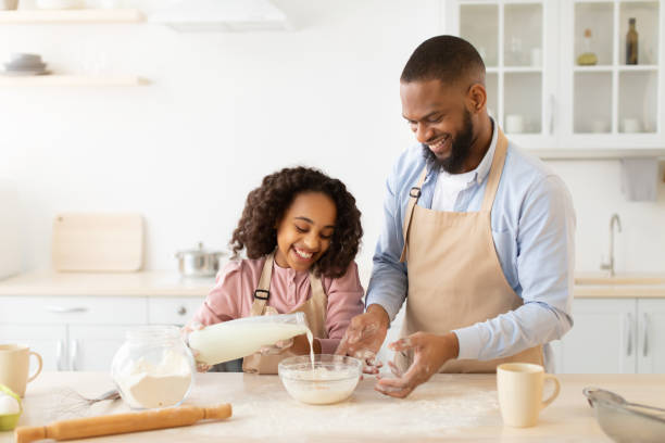 istock Happy afro family preparing dough together in kitchen 1315148207
