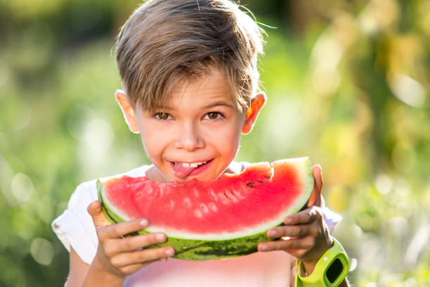 istock happy child eating watermelon 1315149173