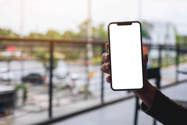 istock a woman holding and showing white mobile phone with blank black desktop screen 1315149965