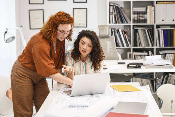istock Two female coworkers trying to solve problem of new project. 1315151332