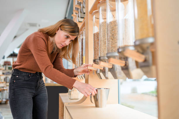 istock Female Costumer Using A Cereal Dispenser In A Sustainable Store 1315151448