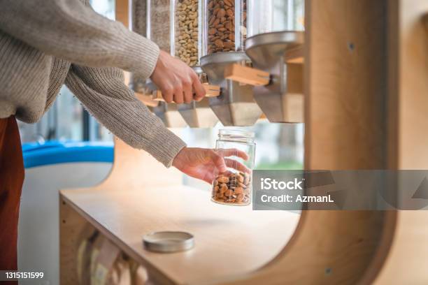 Close Up Of Using A Dispenser For Refilling In A Sustainable Plastic Free Shop Stock Photo - Download Image Now