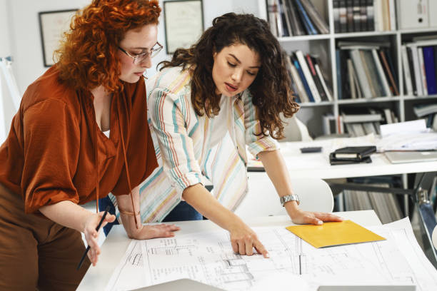 istock Two female coworkers trying to solve problem of new project. 1315151695