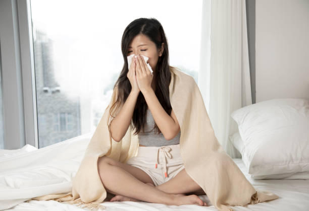 istock Young asian woman is blowing her nose 1315151852