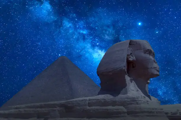 The Great Sphinx and Khafre Pyramid in Giza against night sky with stars and Milky way in Giza, Cairo, Egypt.