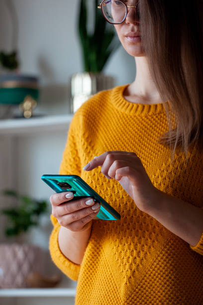 istock Woman using mobile phone, holding in hands 1315154066