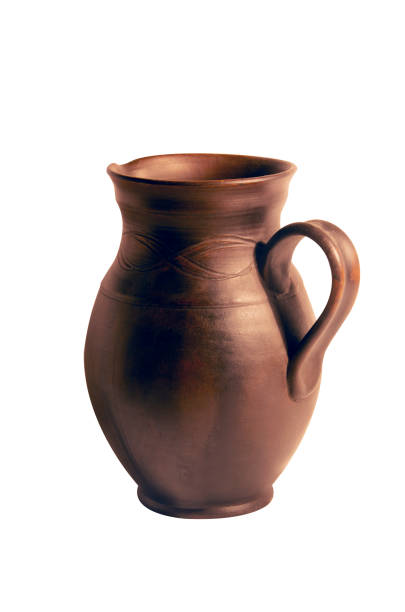istock Old brown clay pitcher for drinks isolated on a white. 1315154991
