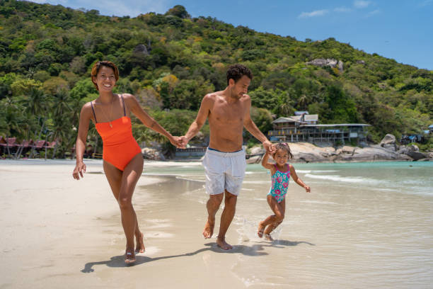 istock Happy family running on the beach 1315156432