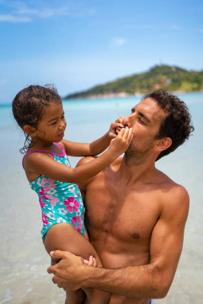 istock Father and daughter having fun on the beach 1315156773