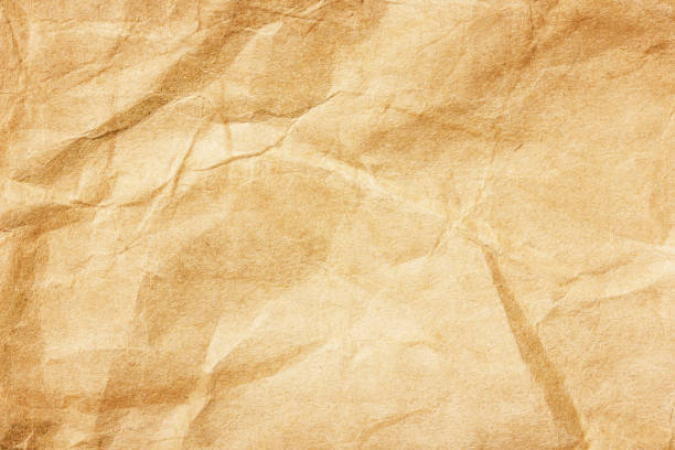 istock Parchment paper background. Coffee stains background. Brown crumpled texture. Burned letter structure. 1315157553