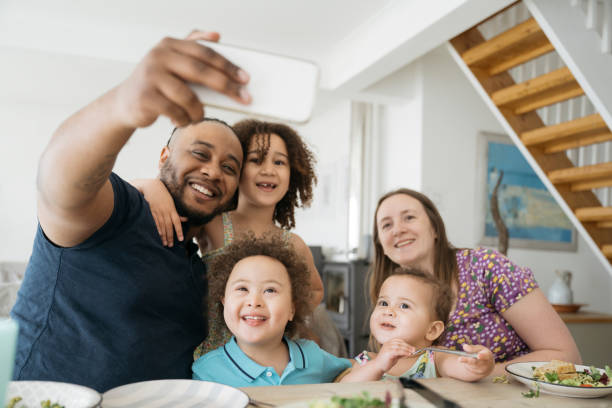 istock Diverse young family smiling for selfie 1315157595