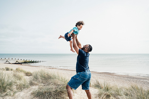 istock Father and son enjoying vacation playtime at Camber Sands 1315157633