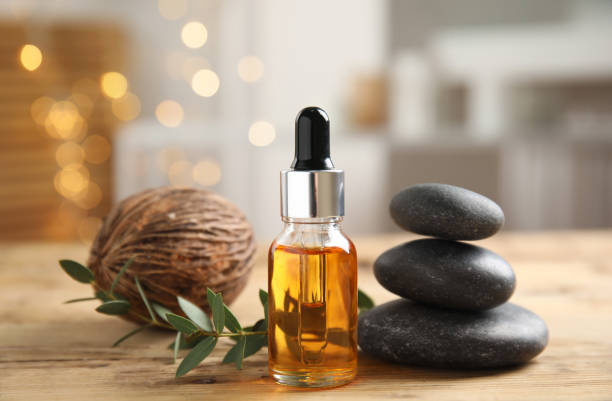 istock Beautiful spa composition with essential oil on wooden table against blurred lights 1315157721