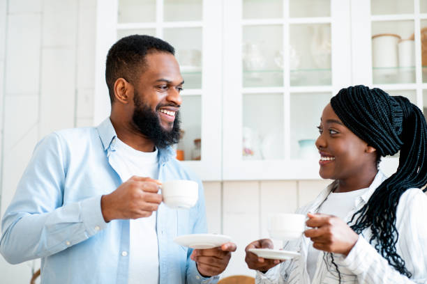 istock Morning Chat. Happy Black Young Couple Drinking Coffee In Kitchen 1315158980