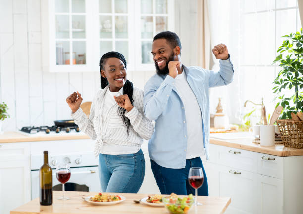 istock Home Date. Joyful Black Couple Dancing In Kitchen After Romantic Lunch 1315159578