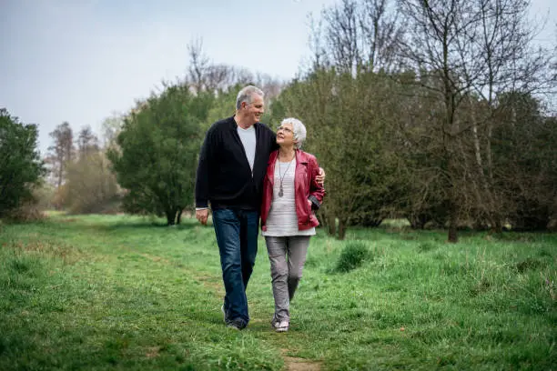 Elderly couple taking in nature, looking happily at each other