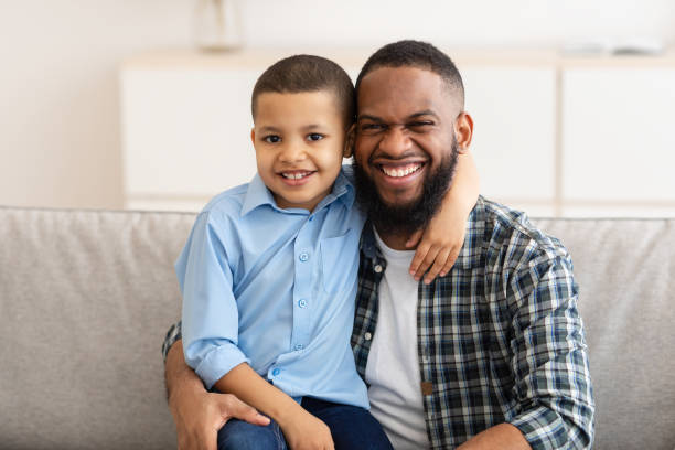 istock Happy African American Daddy And Son Hugging Posing At Home 1315161078