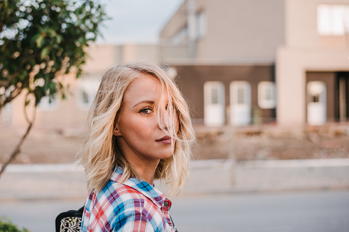 Beautiful blondie in a plaid shirt with hair over her face