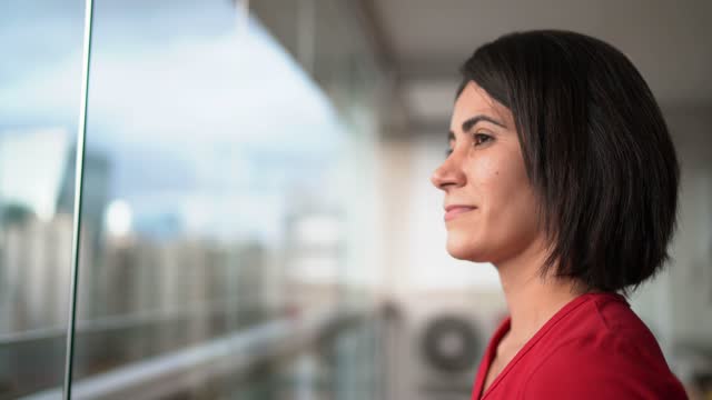 Mid adult woman contemplating at home