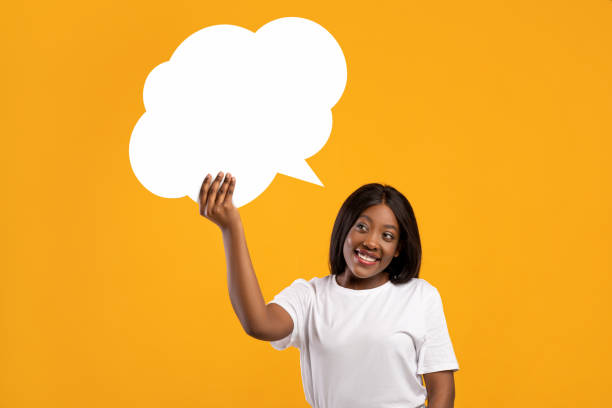 istock Smiling black lady with blank communication bubble, yellow background 1315164701