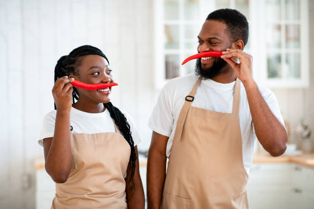 istock Domestic Chefs. Cheerful Black Spouses Having Fun Together In Kitchen While Cooking 1315164840