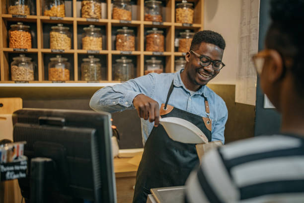 istock Small business owner assisting customer in his store 1315165481