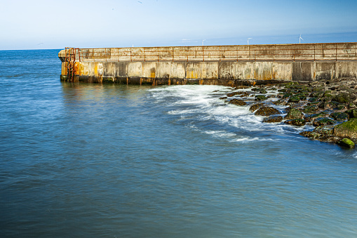 Wave hitting Seaton Sluice Concrete Barier