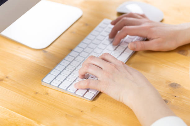 istock An image of a woman's hand is typing on a white keyboard on a wooden table. Selective focus 1315167211