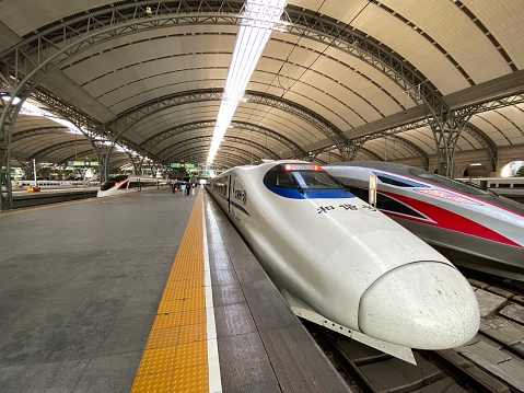 Wuhan.China-April 2021: close up locomotive of China Railway High Speed train in railway station. Wide angle and perspective view.