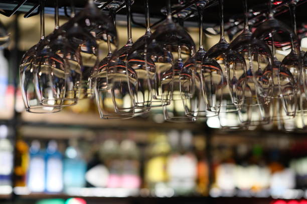 istock drinking glasses hanging in bar rack at dark night 1315169514
