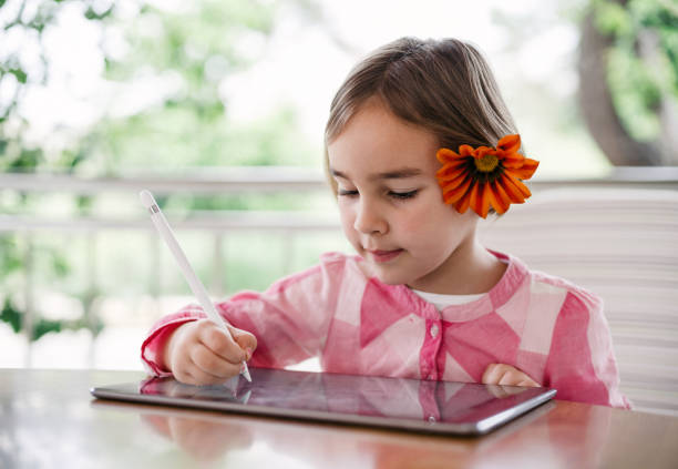 istock Child Girl Drawing Pictures Using Digital Tablet 1315170601
