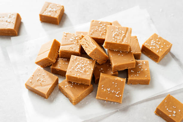 Fresh peanut butter fudge or caramel fudge Fresh homemade peanut butter fudge or caramel fudge on light gray background fudge stock pictures, royalty-free photos & images