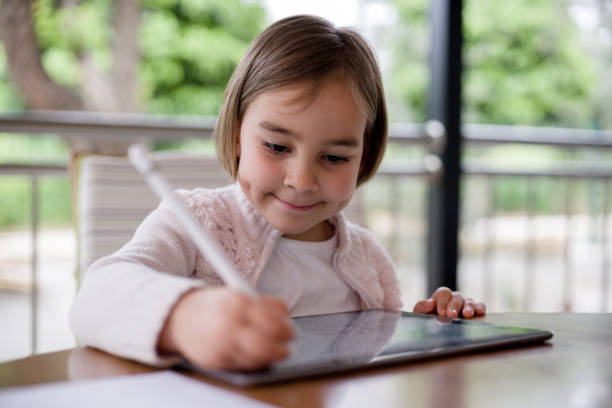 istock Child Girl Drawing Pictures Using Digital Tablet 1315172023