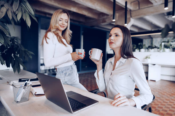 istock Two young women colleagues drinking coffee in office 1315173351