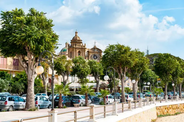 Boulevard with the cathedral of Santissimo Salvatore at Mazara del Vallo. Mazara del Vallo is a town with fishing harbor and a kasbah on the West coast of Sicily.