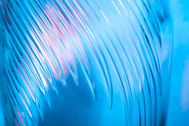 istock Abstract glass background. Texture of wavy glass illuminated with multi-colored light. Pink and blue stains. glass flares. Close up. 1315175394
